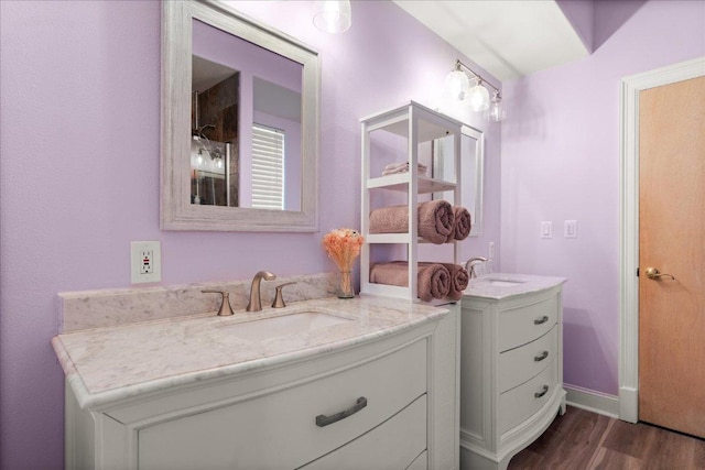 2604 Saratoga Dr, Austin, TX 78733 - full bath featuring two vanities, wood finished floors, and baseboards
