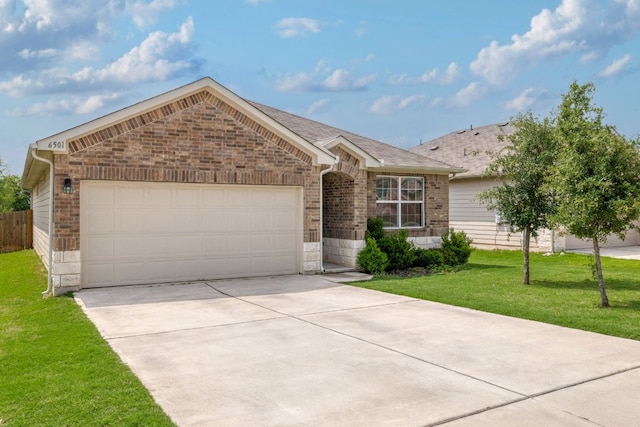 ranch-style house featuring stone siding, a garage, concrete driveway, a front yard, and brick siding