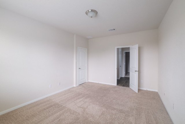unfurnished bedroom featuring carpet and baseboards