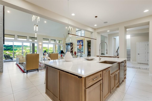 2212 Normandy Vw, Leander, TX 78641 - kitchen with dishwasher, a sink, open floor plan, light countertops, and a kitchen island with sink