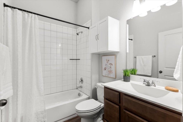 bathroom with toilet, shower / bath combination with curtain, and vanity