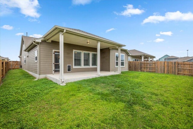back of property with a patio