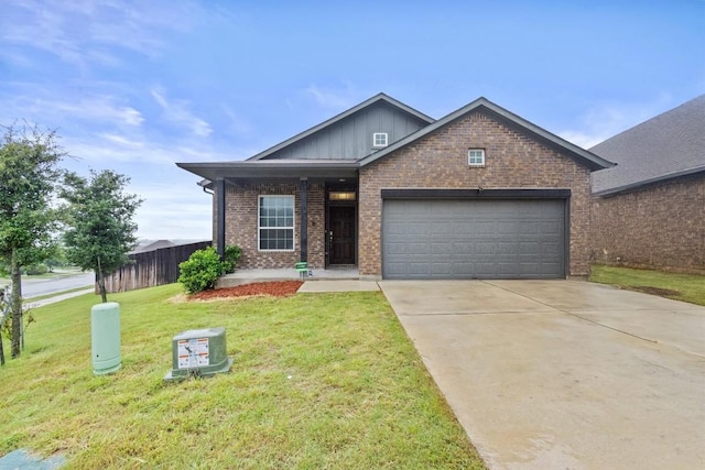 518 Algaroba Loop, Buda, TX 78610 - view of front of house featuring a garage, brick siding, board and batten siding, concrete driveway, and covered porch