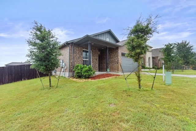 518 Algaroba Loop, Buda, TX 78610 - view of front of house with a garage, brick siding, and driveway
