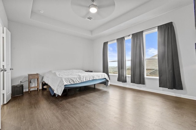 518 Algaroba Loop, Buda, TX 78610 - bedroom with a raised ceiling, wood finished floors, baseboards, and a ceiling fan
