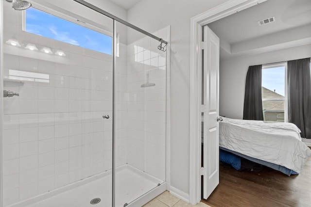 518 Algaroba Loop, Buda, TX 78610 - full bathroom featuring ensuite bath, a stall shower, plenty of natural light, and wood finished floors