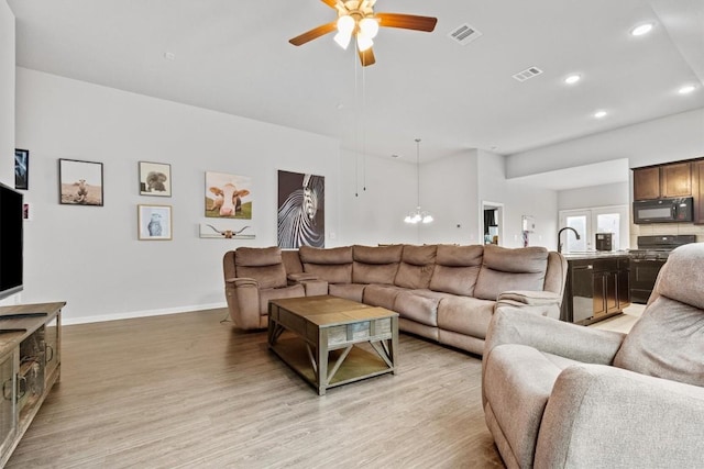 518 Algaroba Loop, Buda, TX 78610 - living room with a ceiling fan, recessed lighting, light wood-type flooring, a chandelier, and baseboards