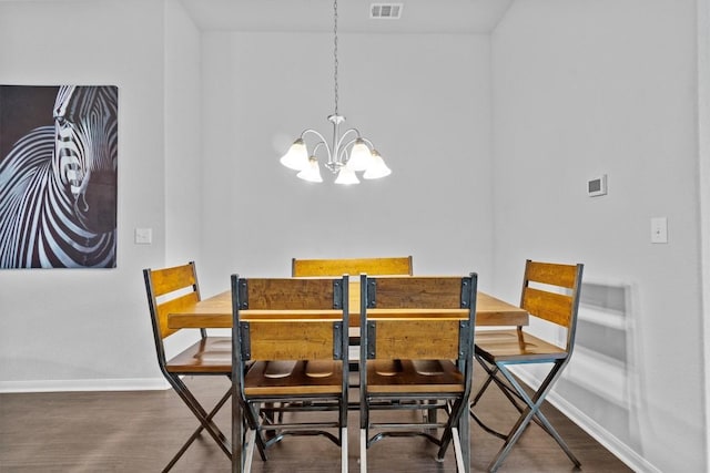 518 Algaroba Loop, Buda, TX 78610 - dining area featuring a chandelier, baseboards, and wood finished floors