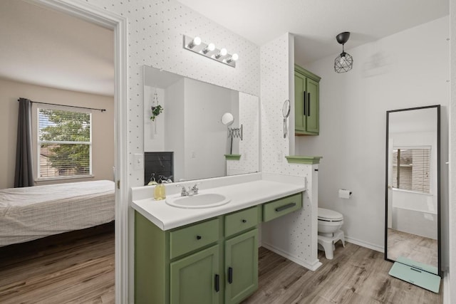 1320 Anna Palm Way, Round Rock, TX 78665 - ensuite bathroom with wood finished floors, vanity, and wallpapered walls