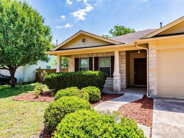 131 Ames Cv, Kyle, TX 78640 - view of front of house with stone siding, covered porch, and a shingled roof