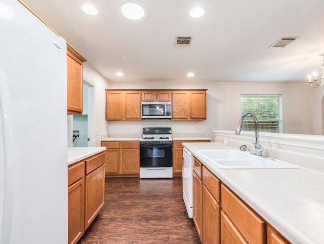 131 Ames Cv, Kyle, TX 78640 - kitchen featuring white appliances, a sink, light countertops, dark wood-style floors, and recessed lighting