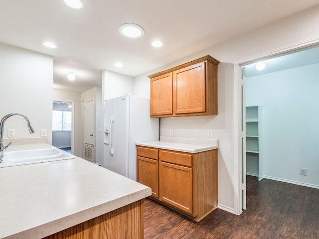 131 Ames Cv, Kyle, TX 78640 - kitchen featuring a sink, dark wood-style floors, white fridge with ice dispenser, light countertops, and recessed lighting