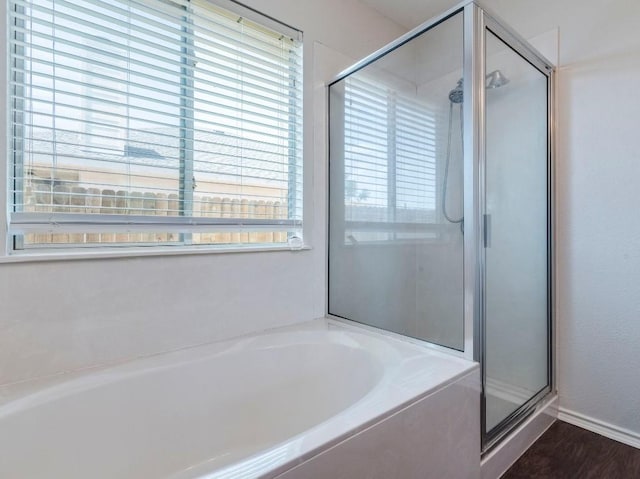 131 Ames Cv, Kyle, TX 78640 - full bath with a shower stall, a bath, and wood finished floors