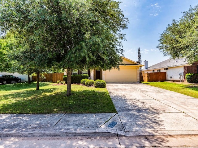 131 Ames Cv, Kyle, TX 78640 - view of property hidden behind natural elements with an attached garage and concrete driveway