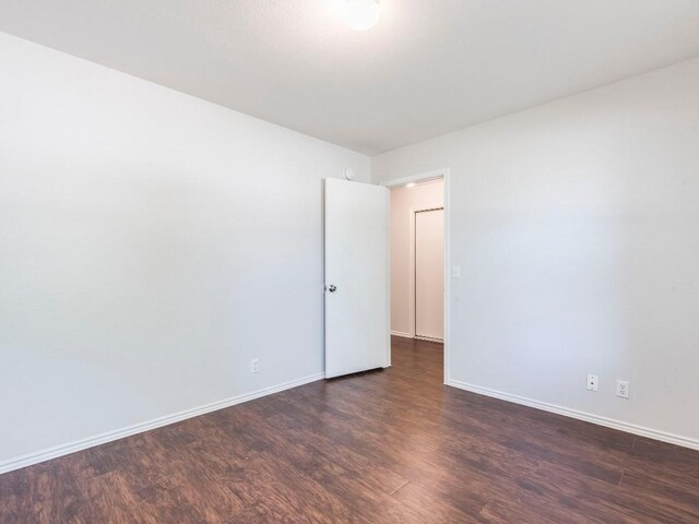 131 Ames Cv, Kyle, TX 78640 - empty room with dark wood-style flooring and baseboards