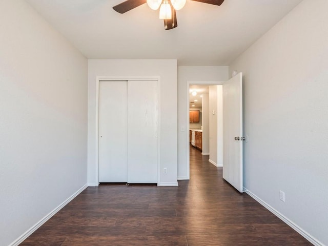 131 Ames Cv, Kyle, TX 78640 - unfurnished bedroom with dark wood finished floors, a closet, and ceiling fan