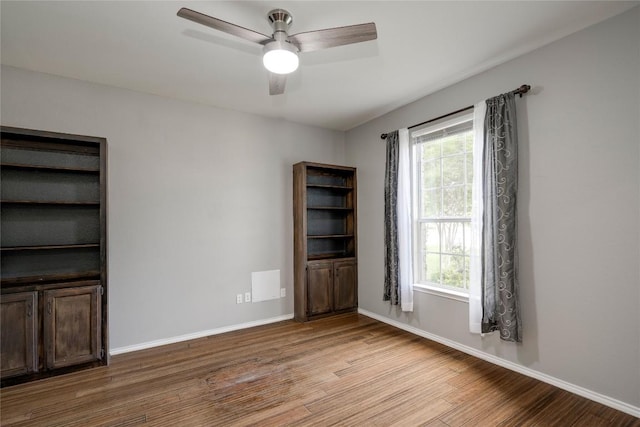 205 Talon Grasp Trl, Leander, TX 78641 - spare room featuring wood finished floors, a ceiling fan, and baseboards