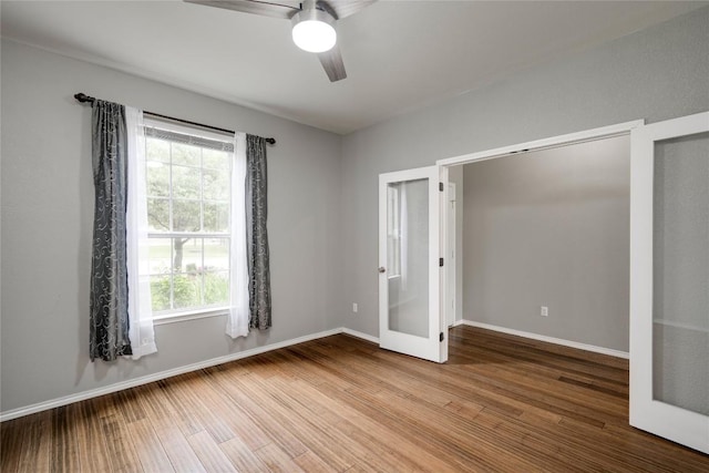 205 Talon Grasp Trl, Leander, TX 78641 - unfurnished bedroom featuring multiple windows, wood finished floors, and french doors