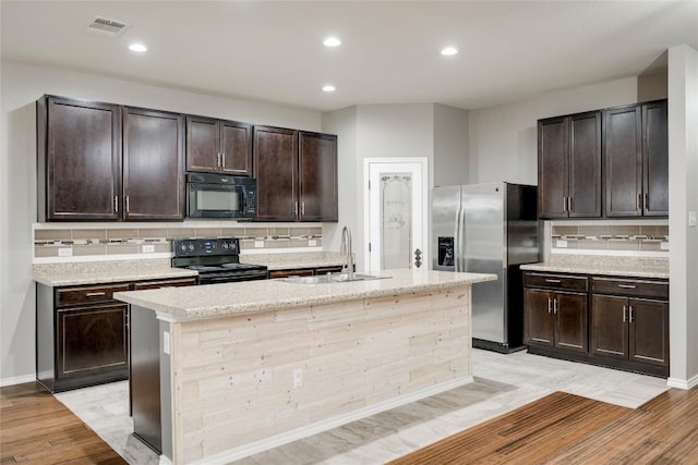 205 Talon Grasp Trl, Leander, TX 78641 - kitchen featuring black appliances, a sink, backsplash, dark brown cabinetry, and recessed lighting