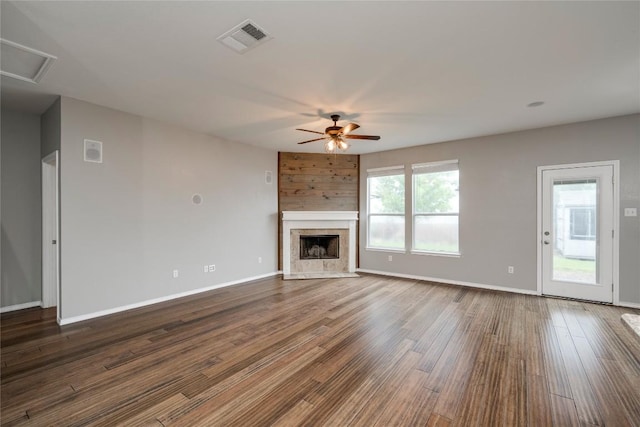 205 Talon Grasp Trl, Leander, TX 78641 - unfurnished living room with a ceiling fan, dark wood-style flooring, a fireplace, and baseboards