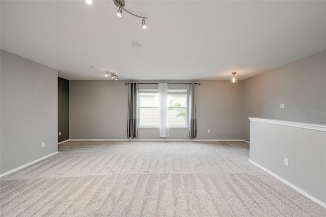 205 Talon Grasp Trl, Leander, TX 78641 - spare room featuring carpet, track lighting, and baseboards
