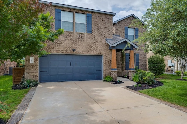 205 Talon Grasp Trl, Leander, TX 78641 - traditional-style house featuring driveway, an attached garage, brick siding, and a front lawn