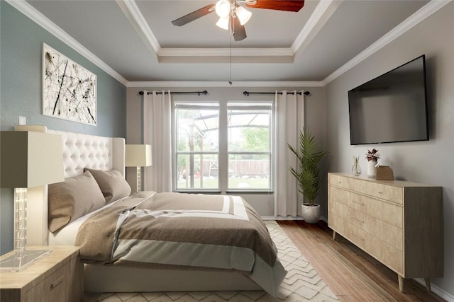 205 Talon Grasp Trl, Leander, TX 78641 - bedroom featuring a raised ceiling, wood finished floors, ornamental molding, and a ceiling fan