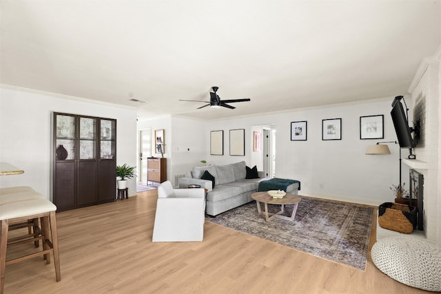 2812 Sissinghurst Dr, Austin, TX 78745 - living area with light wood-style flooring, crown molding, and a ceiling fan