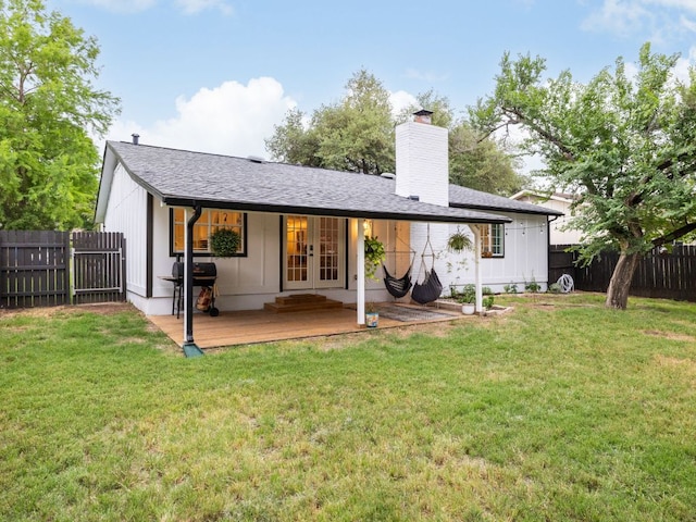 2812 Sissinghurst Dr, Austin, TX 78745 - back of house with french doors, a chimney, and board and batten siding