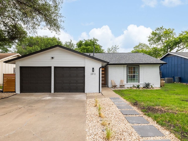 2812 Sissinghurst Dr, Austin, TX 78745 - view of front of property featuring central AC, brick siding, driveway, an attached garage, and roof with shingles