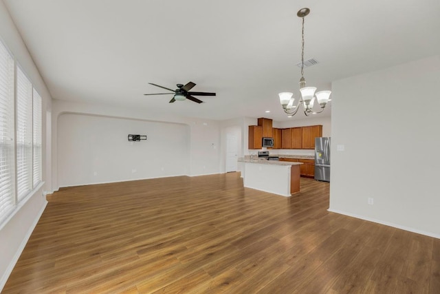 5928 Pescia St, Round Rock, TX 78665 - unfurnished living room with a chandelier, wood finished floors, and a ceiling fan
