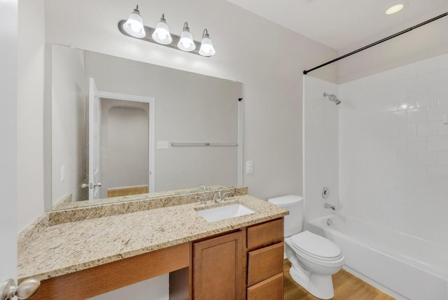 full bathroom with toilet, vanity, and shower / washtub combination