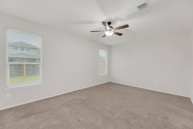 spare room featuring carpet flooring, a ceiling fan, and baseboards