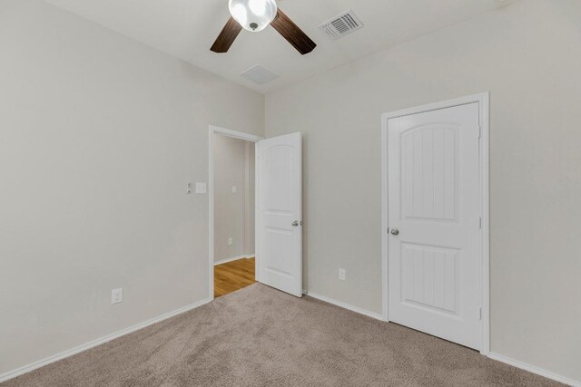 unfurnished bedroom with carpet, baseboards, and a ceiling fan
