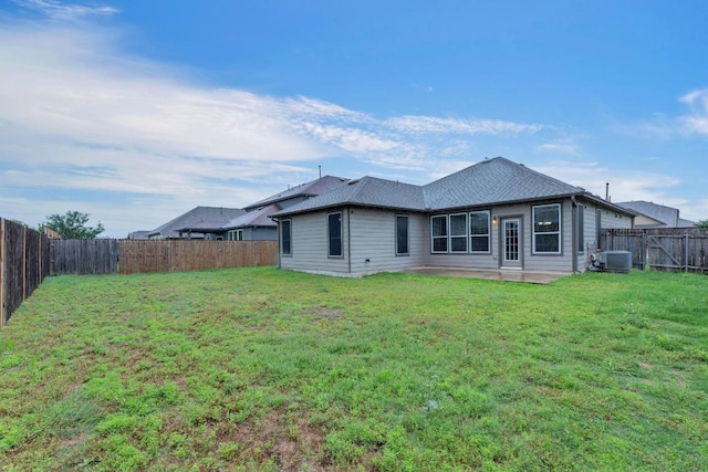 rear view of property with central air condition unit, a patio area, and a shingled roof