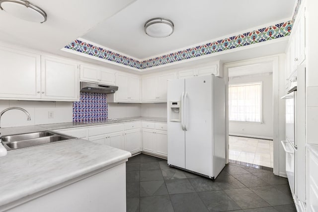 4007 Edgerock Dr, Austin, TX 78731 - kitchen featuring white appliances, a sink, under cabinet range hood, white cabinets, and dark tile patterned flooring