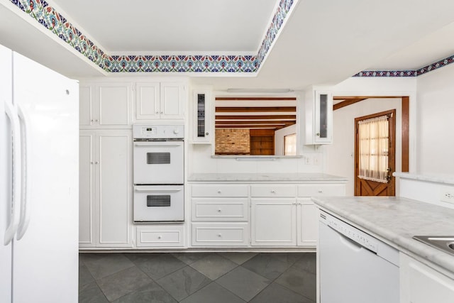 4007 Edgerock Dr, Austin, TX 78731 - kitchen featuring white appliances, light countertops, white cabinets, glass insert cabinets, and dark tile patterned flooring
