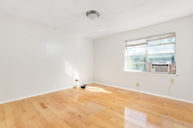 4007 Edgerock Dr, Austin, TX 78731 - empty room featuring hardwood / wood-style flooring, baseboards, and cooling unit