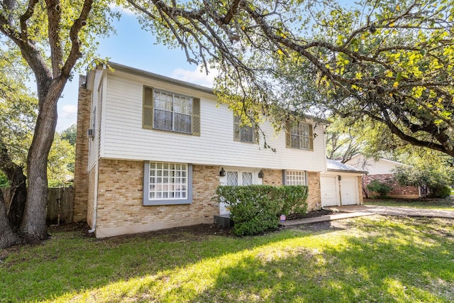 4007 Edgerock Dr, Austin, TX 78731 - colonial house with brick siding, a garage, and driveway