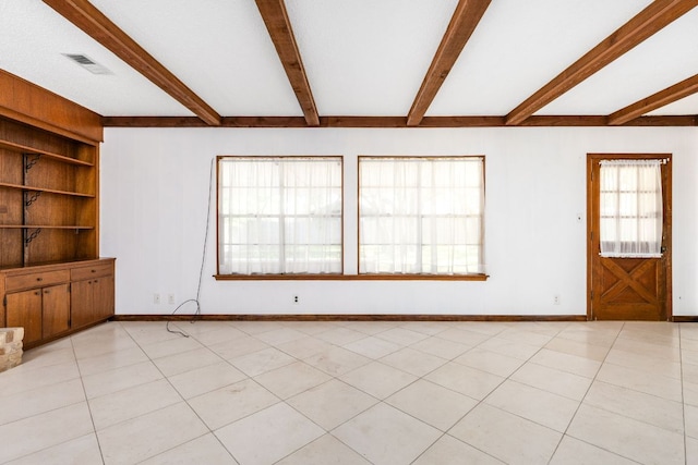 4007 Edgerock Dr, Austin, TX 78731 - unfurnished living room with beam ceiling, built in features, and baseboards
