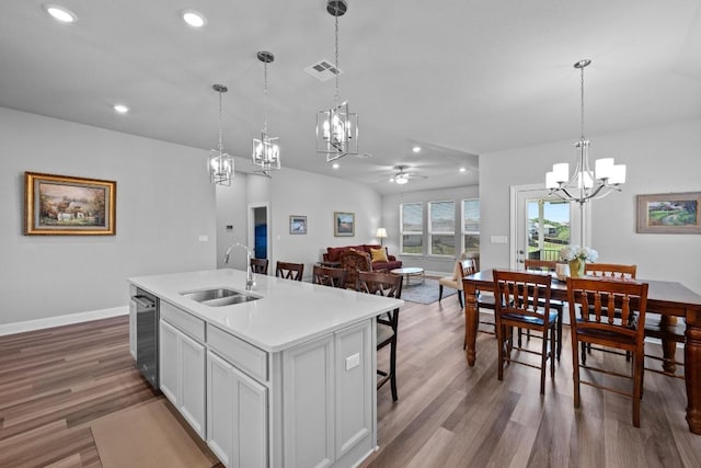 kitchen featuring a chandelier, a sink, a ceiling fan, recessed lighting, and light countertops