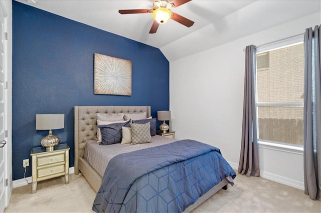 bedroom with carpet floors, vaulted ceiling, baseboards, and ceiling fan