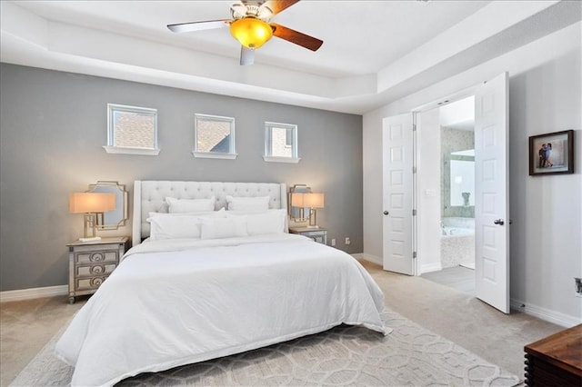 1513 Burr Pkwy, Leander, TX 78641 - bedroom featuring light colored carpet, baseboards, ensuite bathroom, a ceiling fan, and a raised ceiling