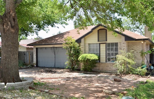 single story home with brick siding, concrete driveway, an attached garage, a chimney, and fence