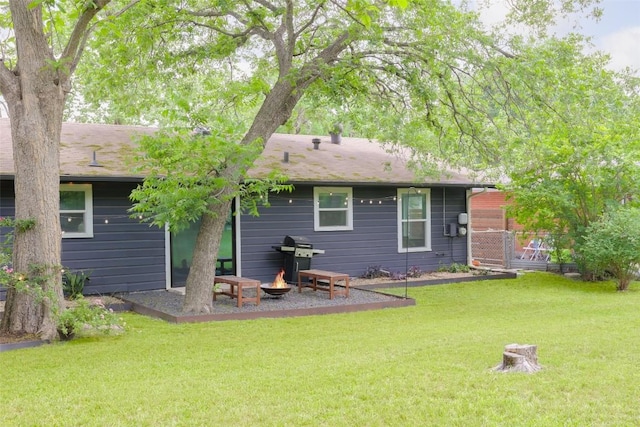 4906 Hilldale Dr, Austin, TX 78723 - back of house with a fire pit and a lawn