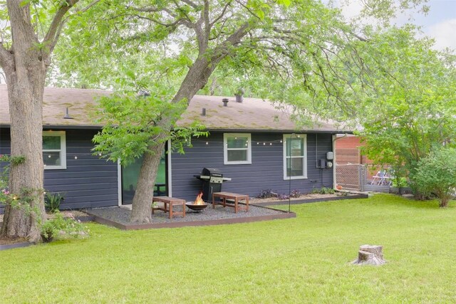 4906 Hilldale Dr, Austin, TX 78723 - back of property with an outdoor fire pit and a lawn