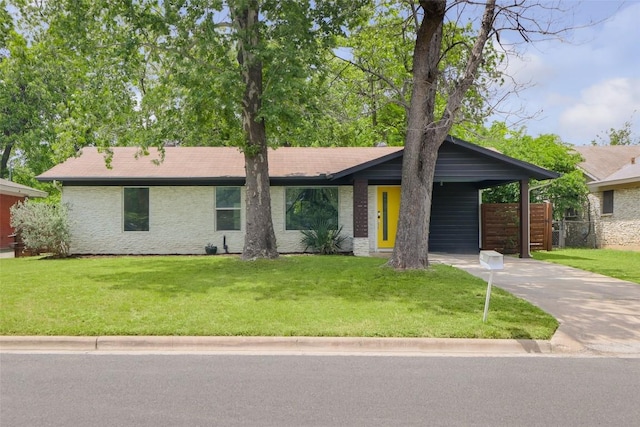 4906 Hilldale Dr, Austin, TX 78723 - mid-century modern home with driveway, a front lawn, and a carport