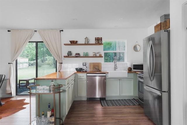 4906 Hilldale Dr, Austin, TX 78723 - kitchen featuring stainless steel appliances, a sink, dark wood finished floors, decorative backsplash, and recessed lighting