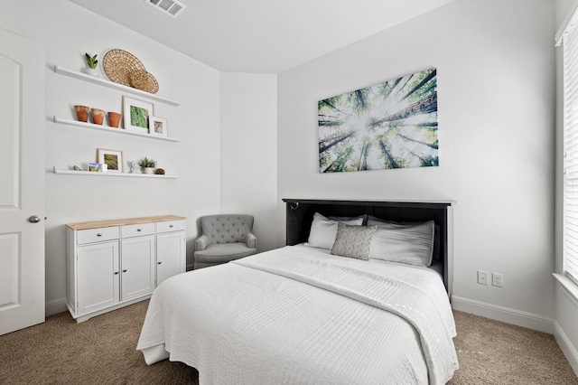 bedroom with light carpet, multiple windows, and baseboards