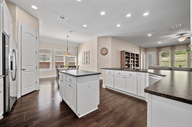 kitchen with dark countertops, appliances with stainless steel finishes, a center island, recessed lighting, and healthy amount of natural light